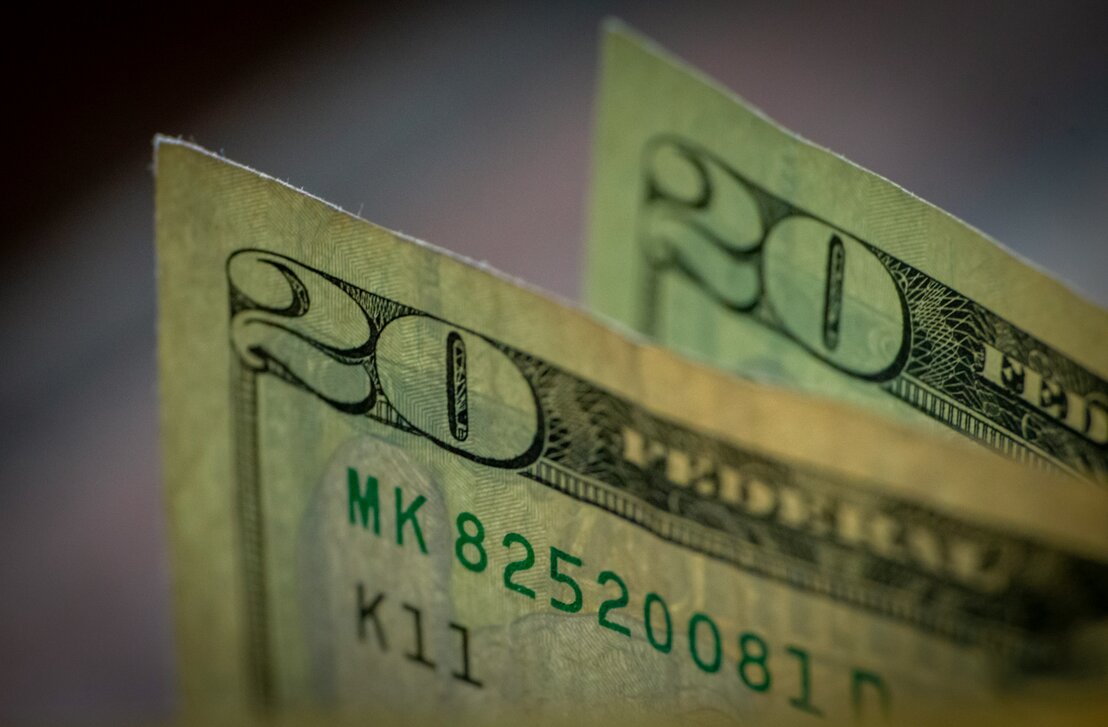 Customer handing over a small down payment at a car dealership