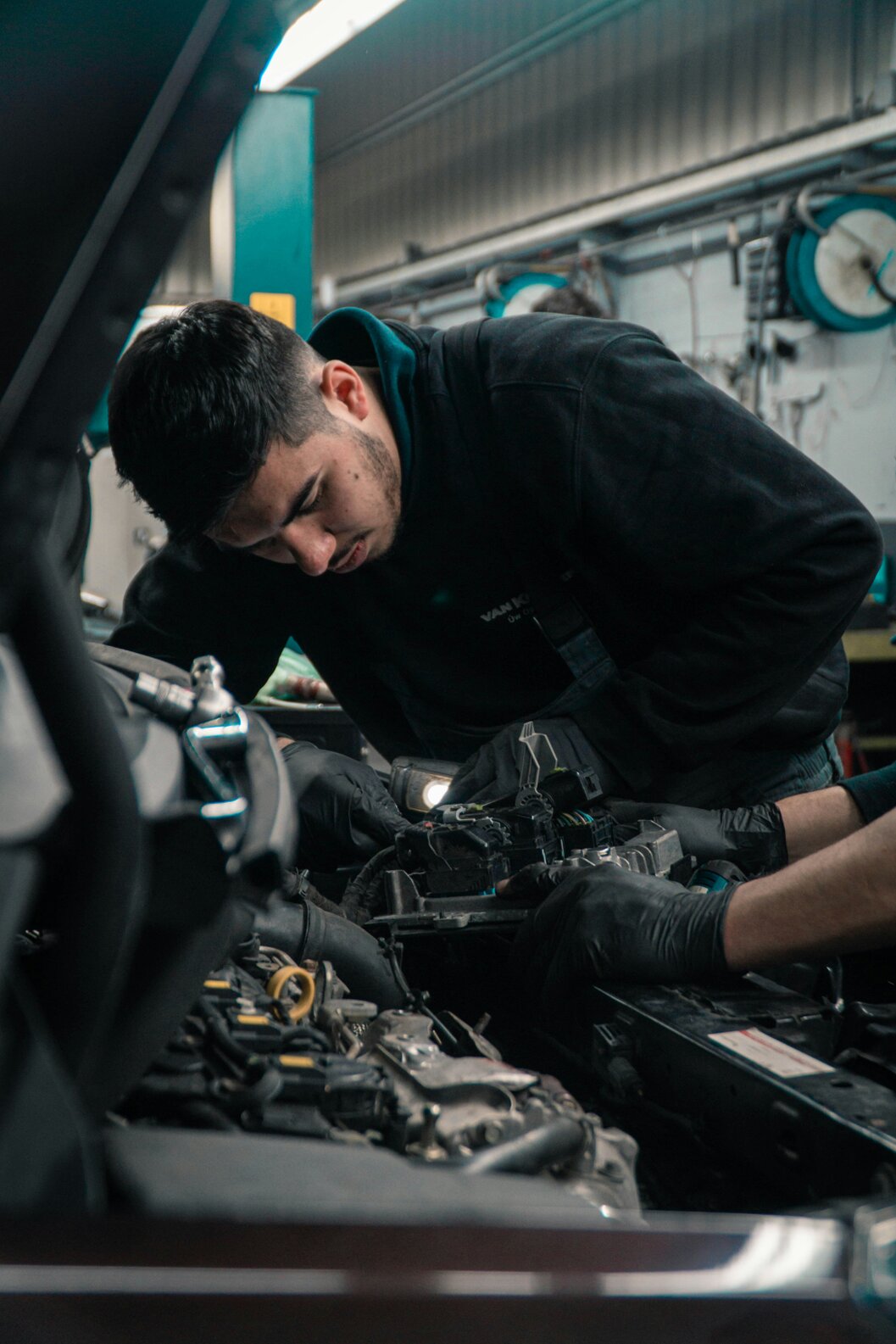 Mechanic performing Texas State Inspection on a car