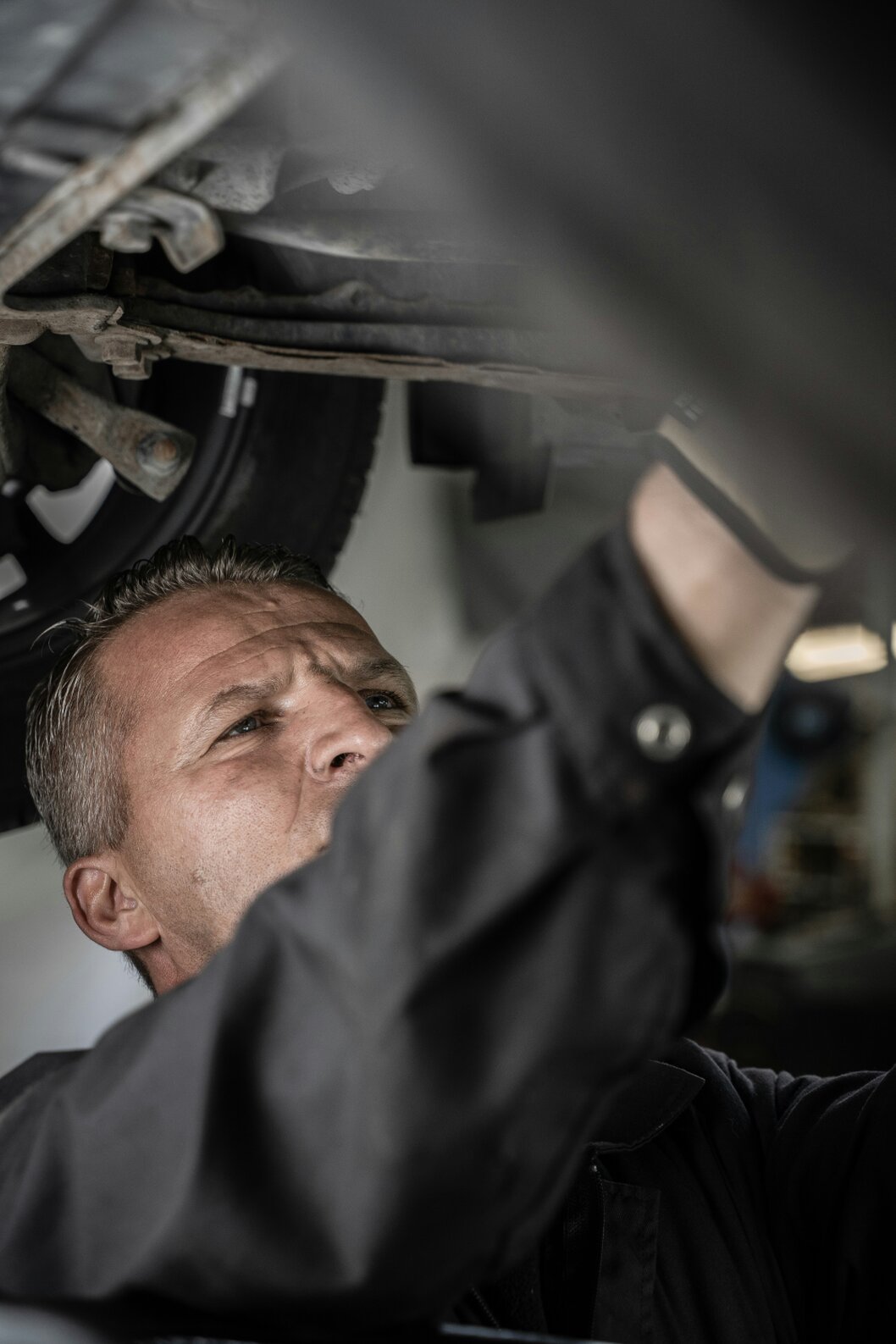 Auto technician working under the hood of a vehicle
