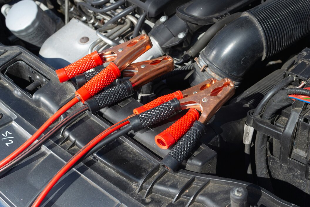 Mechanic testing a car battery with diagnostic equipment